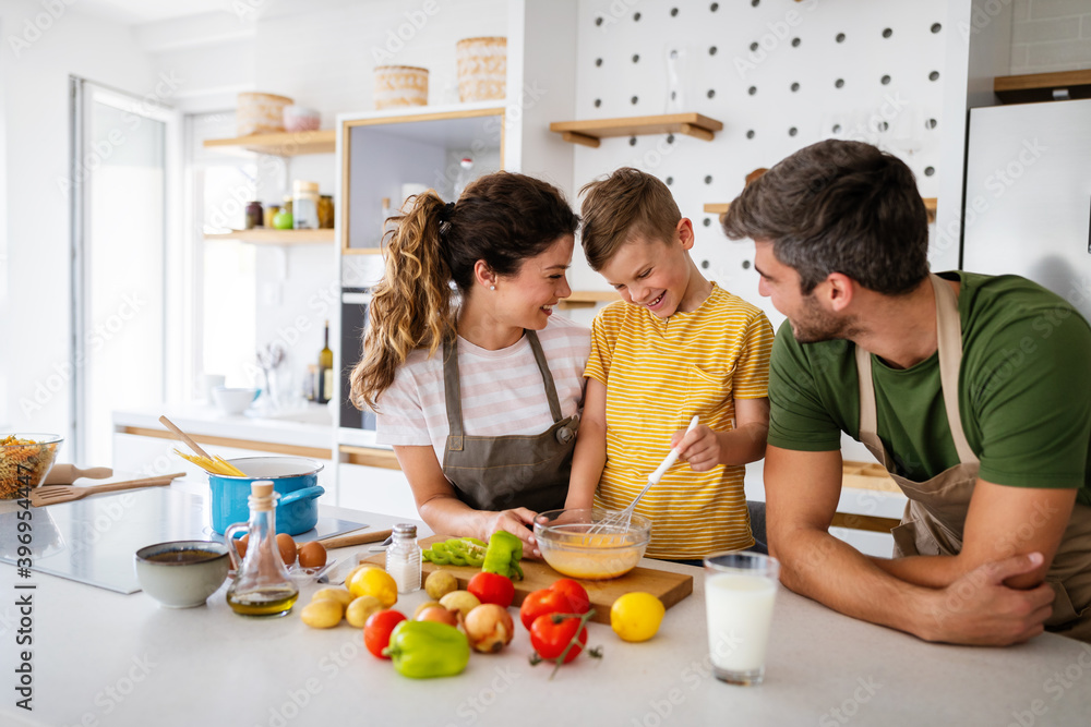 Happy family in the kitchen having fun and cooking together. Healthy food at home. Happy family in the kitchen having fun and cooking together. Healthy food at home.