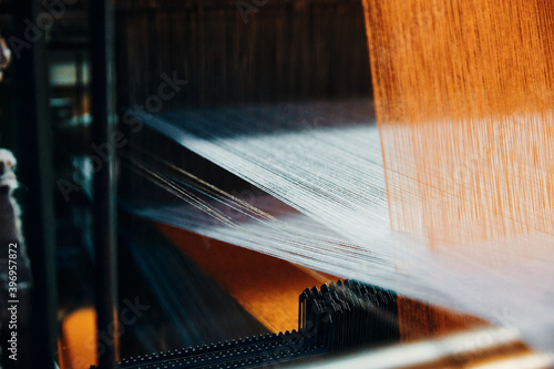 Textile factory machine weaving close up photo