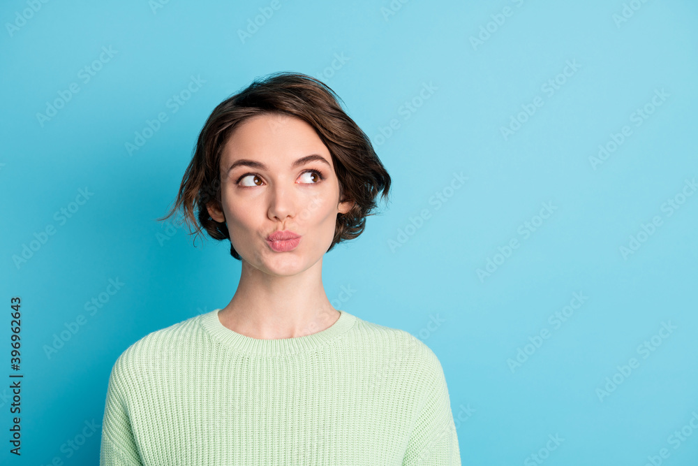 Portrait of cute optimistic short hairdo girl look empty space wear lime sweater isolated on teal color background Portrait of cute optimistic short hairdo girl look empty space wear lime sweater isolated on teal color background