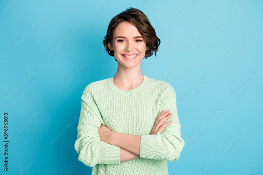 Portrait of optimistic cute short hairdo girl hands crossed wear lime sweater isolated on teal color background Portrait of optimistic cute short hairdo girl hands crossed wear lime sweater isolated on teal color background