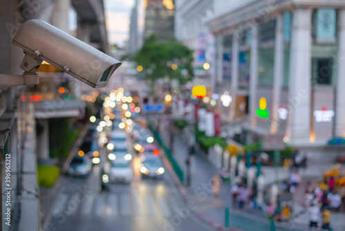 Photography Close up CCTV security camera with blur of traffic jam in the background, Traffic security camera surveillance (CCTV) in the big city