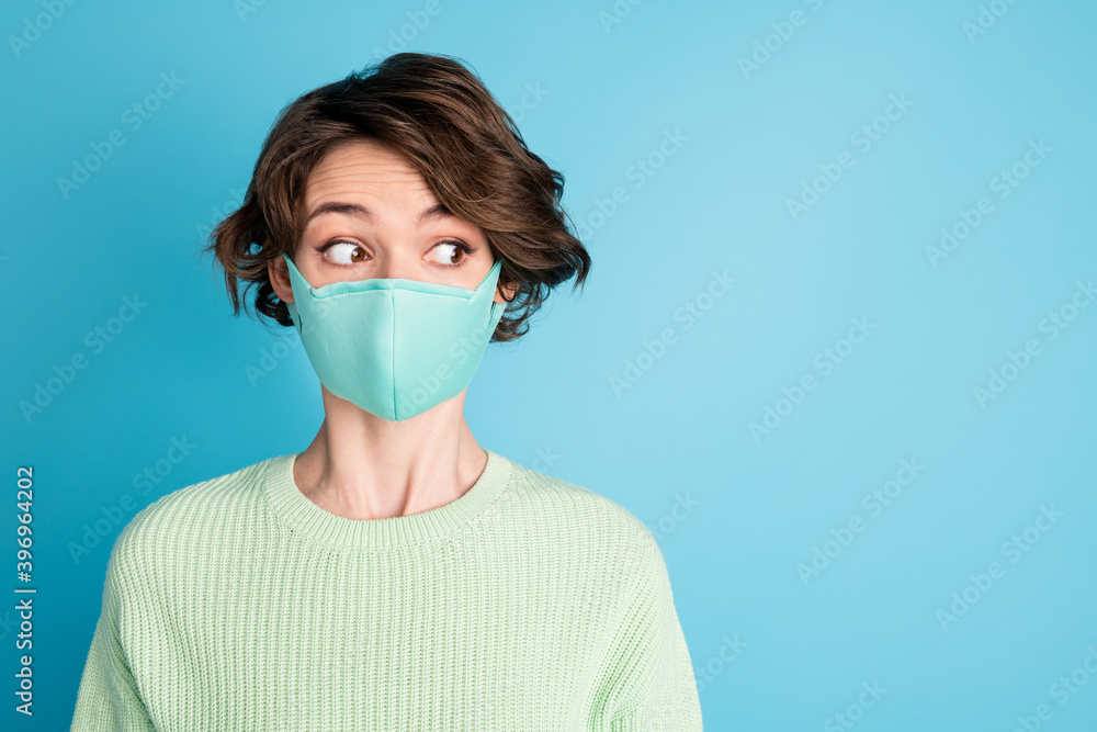 Portrait of impressed short hairdo girl look empty space wear face mask lime sweater isolated on teal color background Portrait of impressed short hairdo girl look empty space wear face mask lime sweater isolated on teal color background