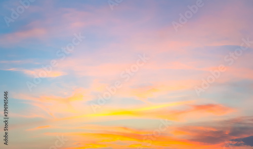 Beautiful vivid sky with cloud painted by the sun before sunset in winter. Colorful sky on evening time. Bright blue, orange and yellow colors sunset . © somchairakin