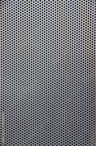 Perforated metal mesh as a texture or background in portrait format. High quality photo