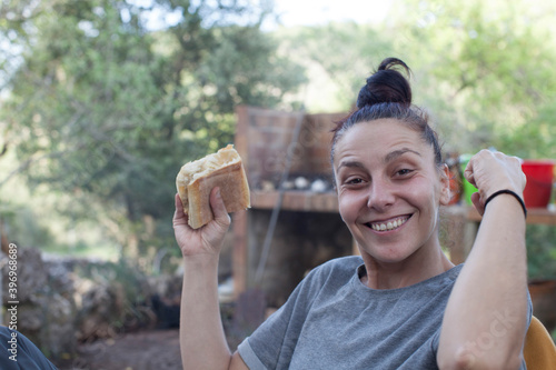 Portrait of a woman eating a sandwich