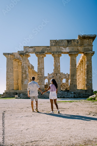 A couple visit Greek temples at Selinunte during vacation, View on sea and ruins of greek columns in Selinunte Archaeological Park Sicily Italy photo