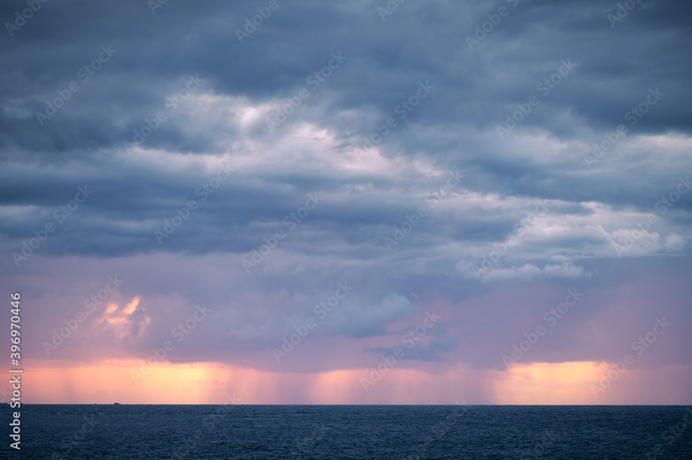 Rain clouds over the sea during sunset