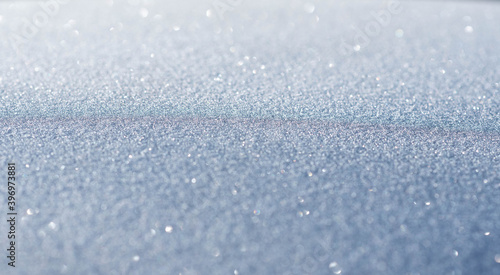Surface covered with frost, natural winter texture and banner background, macro photography with sparkles and bokeh, shallow depth of field