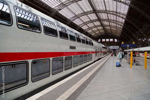 Two colored trains on railway station in germany