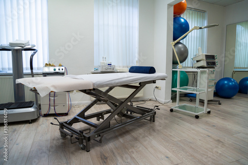 Medical cabinet for physiotherapywith massage couch and equipment