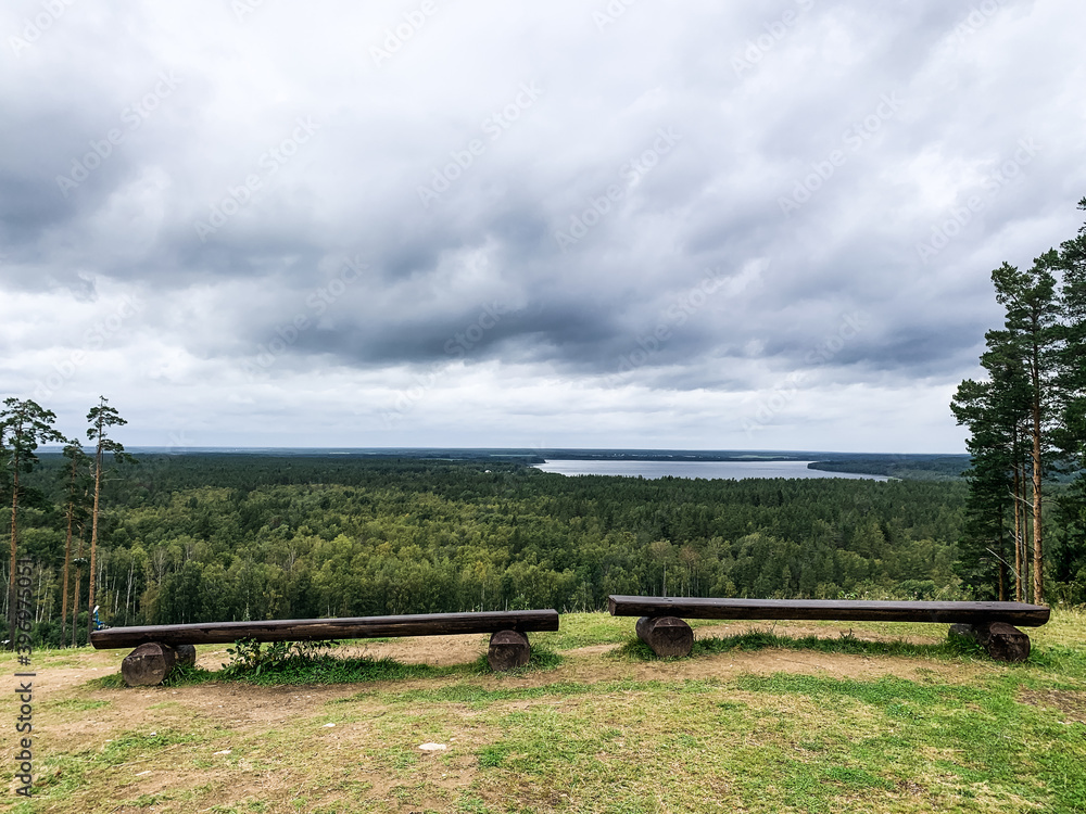 Fototapeta premium Two benches with the lake view