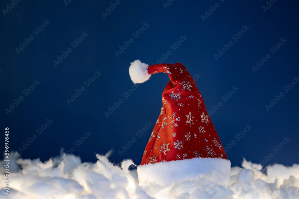 Red santa hat in the snow.
