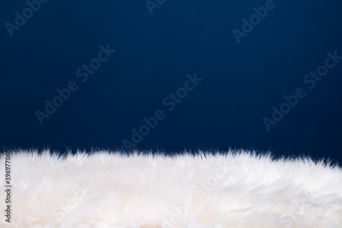 Картината върху платно Texture of fluffy fur on blue background.