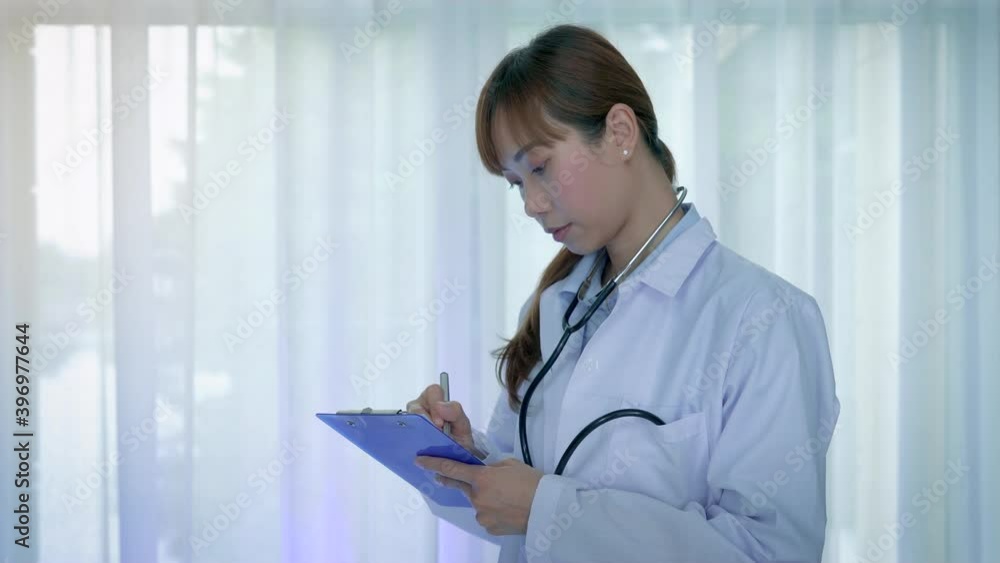 Asian Female Doctor in white coat with Medical stethoscope and Patient prescription, Portrait Young Asian Medical physician doctor. Asian Female Doctor in white coat with Medical stethoscope and Patient prescription, Portrait Young Asian Medical physician doctor.