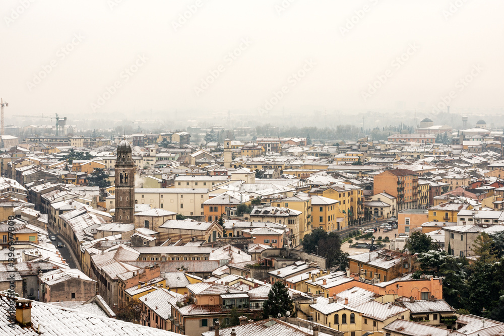 Aerial view of Verona downtown in winter with snow with the Church of San Tommaso Becket Cantuariense in gothic style (XIV-XVI century). Veneto, Italy, Europe.