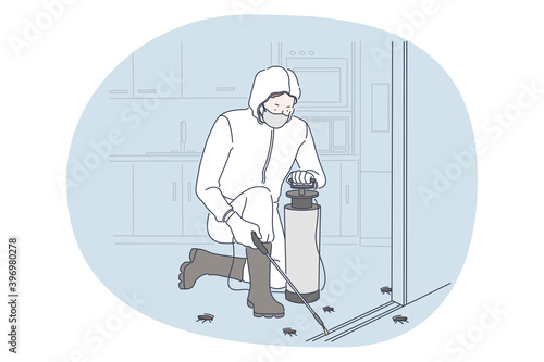 Working with disinfecting, job, profession concept. Man professional exterminator in white protective uniform and boots disinfecting apartment from cockroach and insects. Job specialist, work
