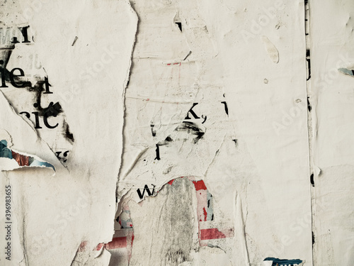 Vintage old posters stuck and torn on the wall in your grunge background