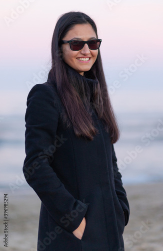 Portrait of a young woman at the beach with winter clothing. © Antonio Gravante