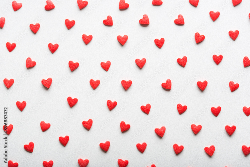 red and white pattern background for Valentine's day. hearts are evenly spread out on surface