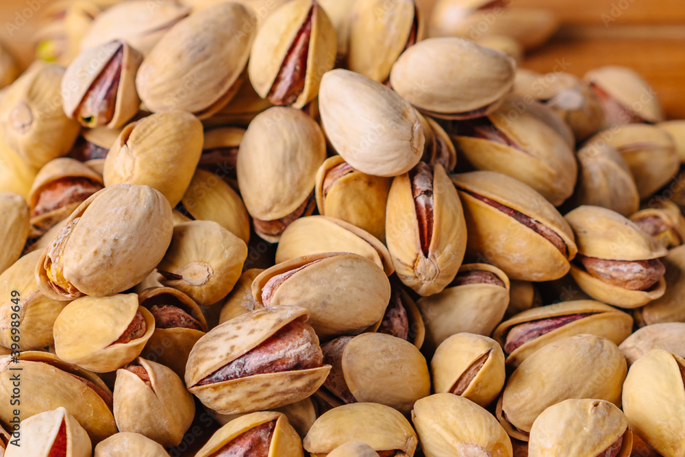 Green fresh pistachios as texture on wooden background Green fresh pistachios as texture on wooden background