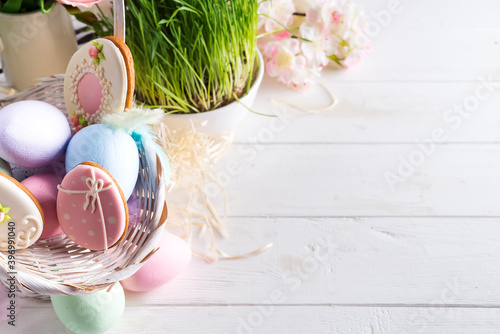 Photography Easter greeting card with glazed cookies and colorful easter eggs in basket