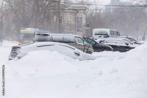 January, 2016 - Vladivostok, Russia - Heavy snowfall in Vladivostok. Snow-covered cars stand along the roadside during heavy snow