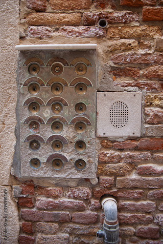 Old doorbell on the wall of a house entrance on a street in Venice