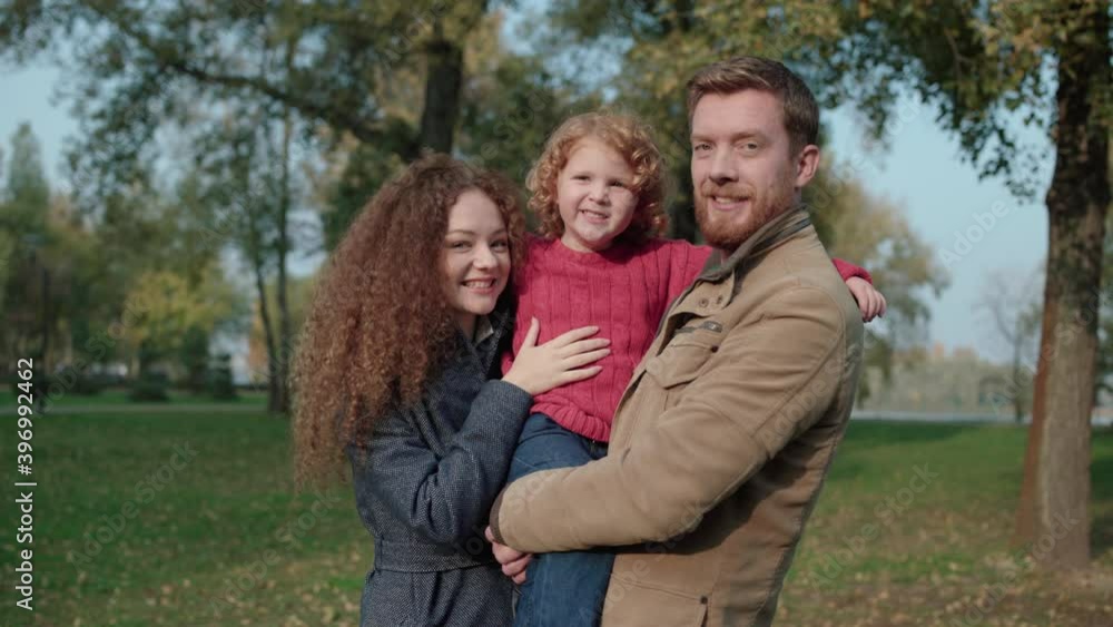 Cheerful red-haired parents and son smiling at camera, family happiness, rest Cheerful red-haired parents and son smiling at camera, family happiness, rest