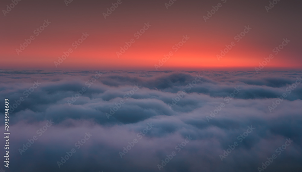 Above the sea of clouds in the valley at morning sunrise