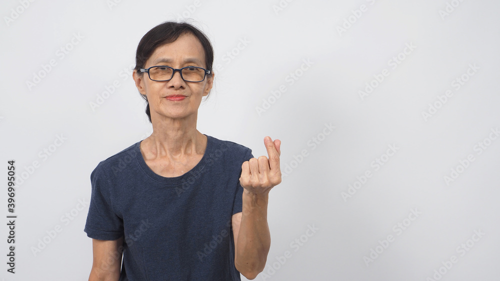 Asian senior or older woman doing miniheart hand sign on white background. Asian senior or older woman doing miniheart hand sign on white background.