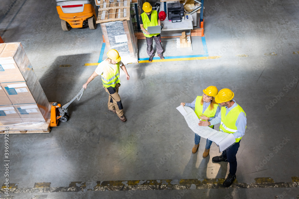 Fototapeta premium Group of warehouse workers at work, above view