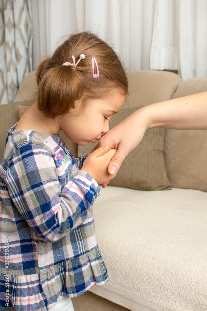 Little girl kissing her parent's hand. Muslim tradition in Eid Mubarak. Child show respect for mother or grandmother during Ramadan (aka: Ramazan bayrami). Little girl kissing her parent's hand. Muslim tradition in Eid Mubarak. Child show respect for mother or grandmother during Ramadan (aka: Ramazan bayrami).