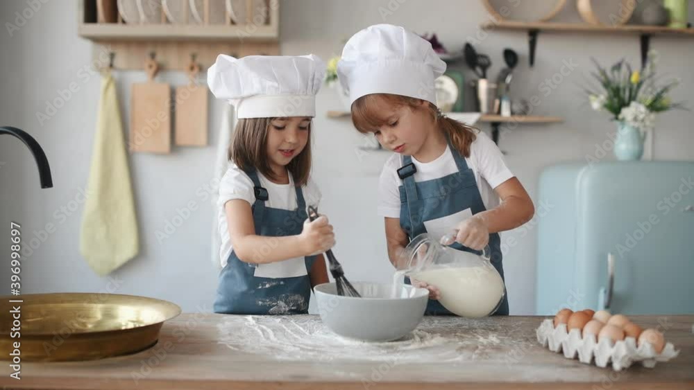 Two girls are cooking in the kitchen Two girls are cooking in the kitchen