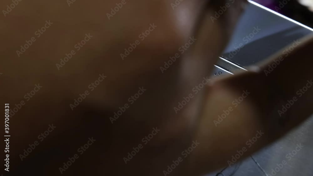 close up view of African American black hand with long nails using a sewing machine to manufacture fabric for mask creation. the thread bobber goes up and down to design pretty patterns close up view of African American black hand with long nails using a sewing machine to manufacture fabric for mask creation. the thread bobber goes up and down to design pretty patterns