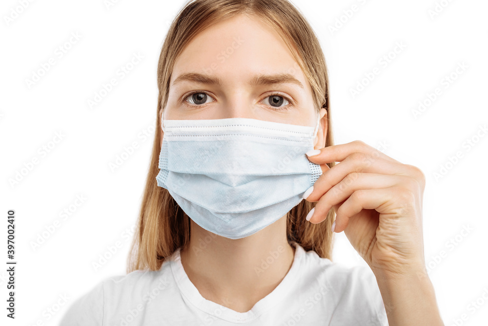 Young woman in protective mask, on an isolated white background. Influenza, allergies, virus protection, coronavirus pandemic Young woman in protective mask, on an isolated white background. Influenza, allergies, virus protection, coronavirus pandemic