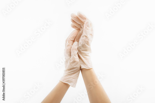 Medical nitrile gloves, a human hand wears a latex glove. Doctor or nurse putting on protective gloves, on white background