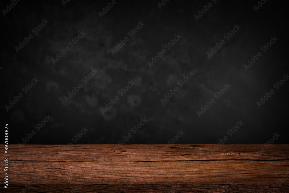 Free space on a wooden table for displaying products with a blurred black wall background. Free space on a wooden table for displaying products with a blurred black wall background.