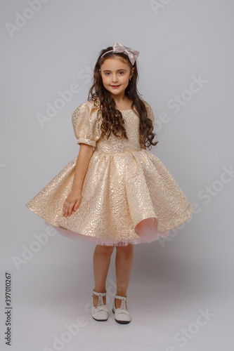little girl in a beautiful dress on a white background © Olesya Pogosskaya