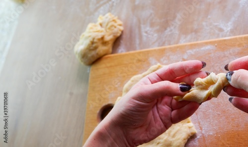 Homemade bread baking. Closeup woman hands kneading The Dough. Beautiful, cook. Dough for pizza or bread.