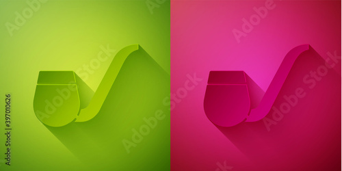 Paper cut Smoking pipe with smoke icon isolated on green and pink background. Tobacco pipe. Paper art style. Vector.