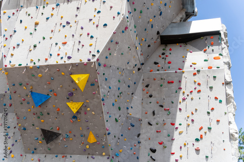 Artificial rock climbing showing various colored grips