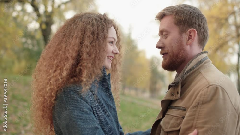 Loving boyfriend and girlfriend talking outdoors, touching foreheads, romance Loving boyfriend and girlfriend talking outdoors, touching foreheads, romance