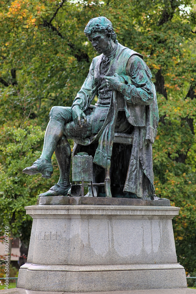 Statue of chemist Carl Wilhelm Scheele under the rain in Humlegarden park in Stockholm, Sweden