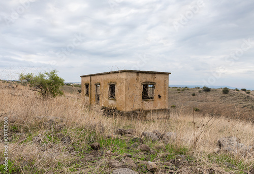 An abandoned  building with traces of bullets has stood since the Yom Kippur War in the Golan Heights in northern Israel photo