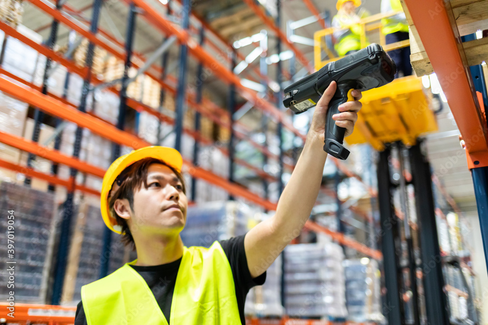 Workers in warehouse scanning packages Workers in warehouse scanning packages