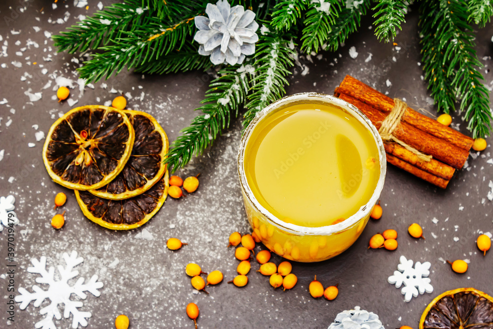 Festive low alcoholic fruit cocktail with sea buckthorn, lemon slices and cinnamon sticks Festive low alcoholic fruit cocktail with sea buckthorn, lemon slices and cinnamon sticks