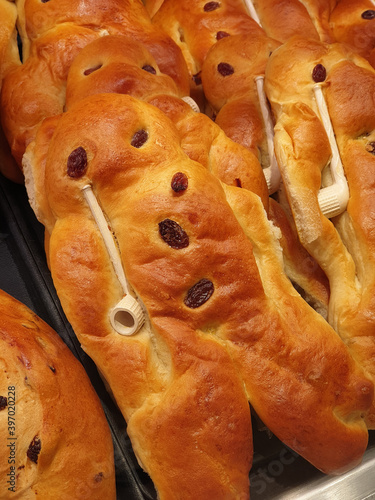 Stutenkerl or weckmann in bakery. Traditional holiday cooking pastries. Bun with raisins