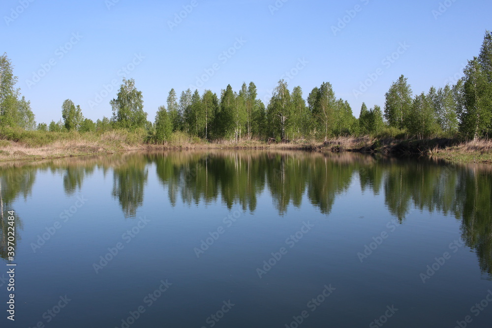 picturesque lake reservoir in the forest in summer for fishing and swimming