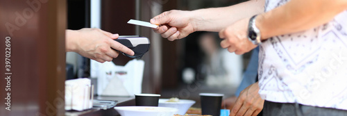 Slika na platnu Client pays with bank plastic card in cafe