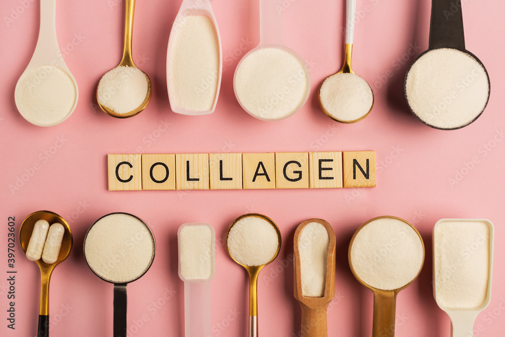 Collagen powder and pills spoons on pink background. Extra protein intake. Natural beauty and health supplement for skin, bones, joints and gut. Plant or fish based. Flatlay, top view. Copy space. Collagen powder and pills spoons on pink background. Extra protein intake. Natural beauty and health supplement for skin, bones, joints and gut. Plant or fish based. Flatlay, top view. Copy space.